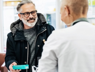 Man speaking with pharmacist