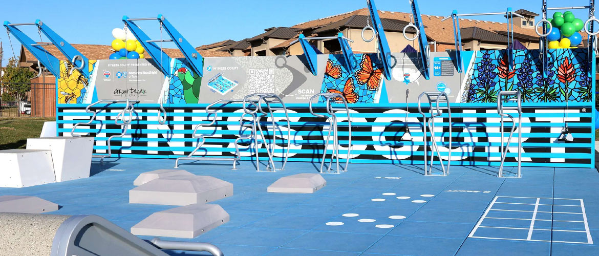 Outdoor excercise equipment with colorful murals depicting flowers, bees and butterflies